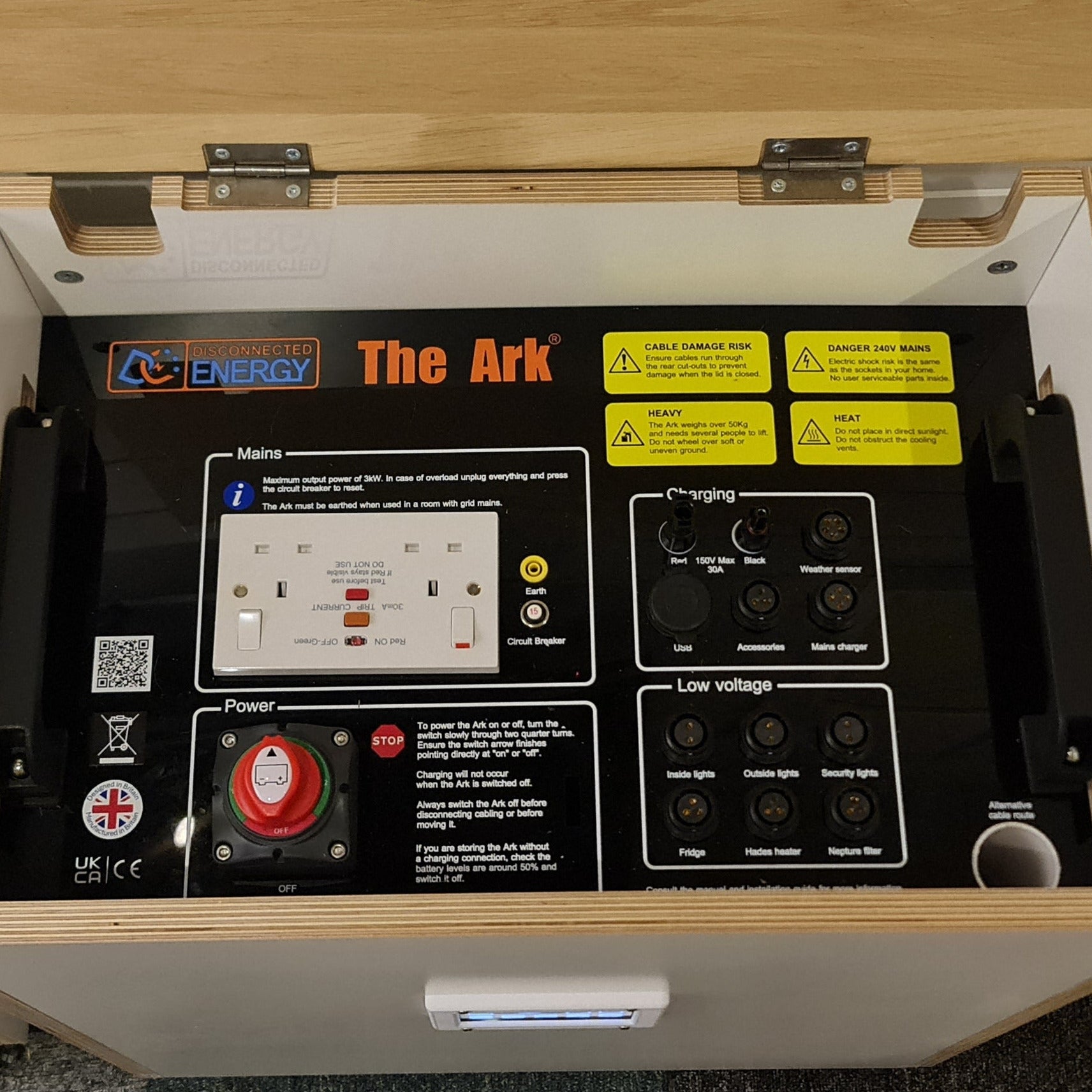 Open wooden box containing electronic equipment of a solar generator, labeled 'The Ark' 