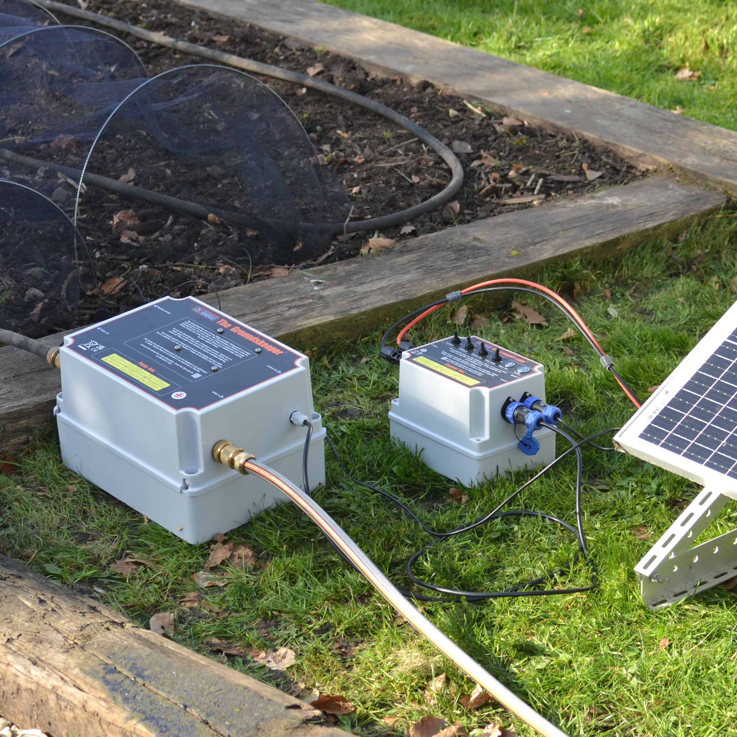 The Groundskeeper solar powered garden water pump system on a grassy background