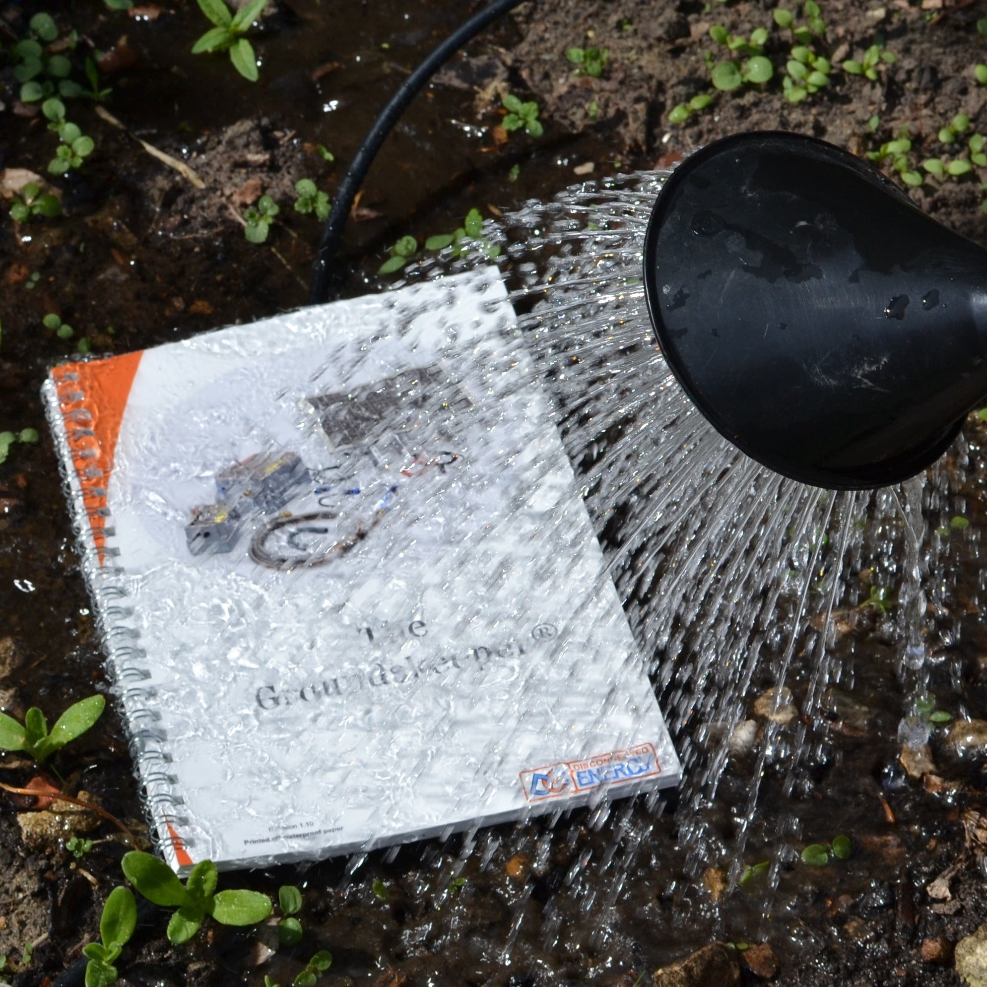 Manual for the Groundskeeper, printed on waterproof paper. being tested by giving it a good soaking from a watering can. 